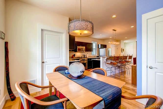 810 East Baseline Road, Unit B Lafayette, CO 80026 - Photo 8 of 28 a view of a dining room with furniture a chandelier and wooden floor