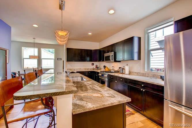 810 East Baseline Road, Unit B Lafayette, CO 80026 - Photo 10 of 28 a kitchen with stainless steel appliances granite countertop counter space a sink refrigerator and cabinets