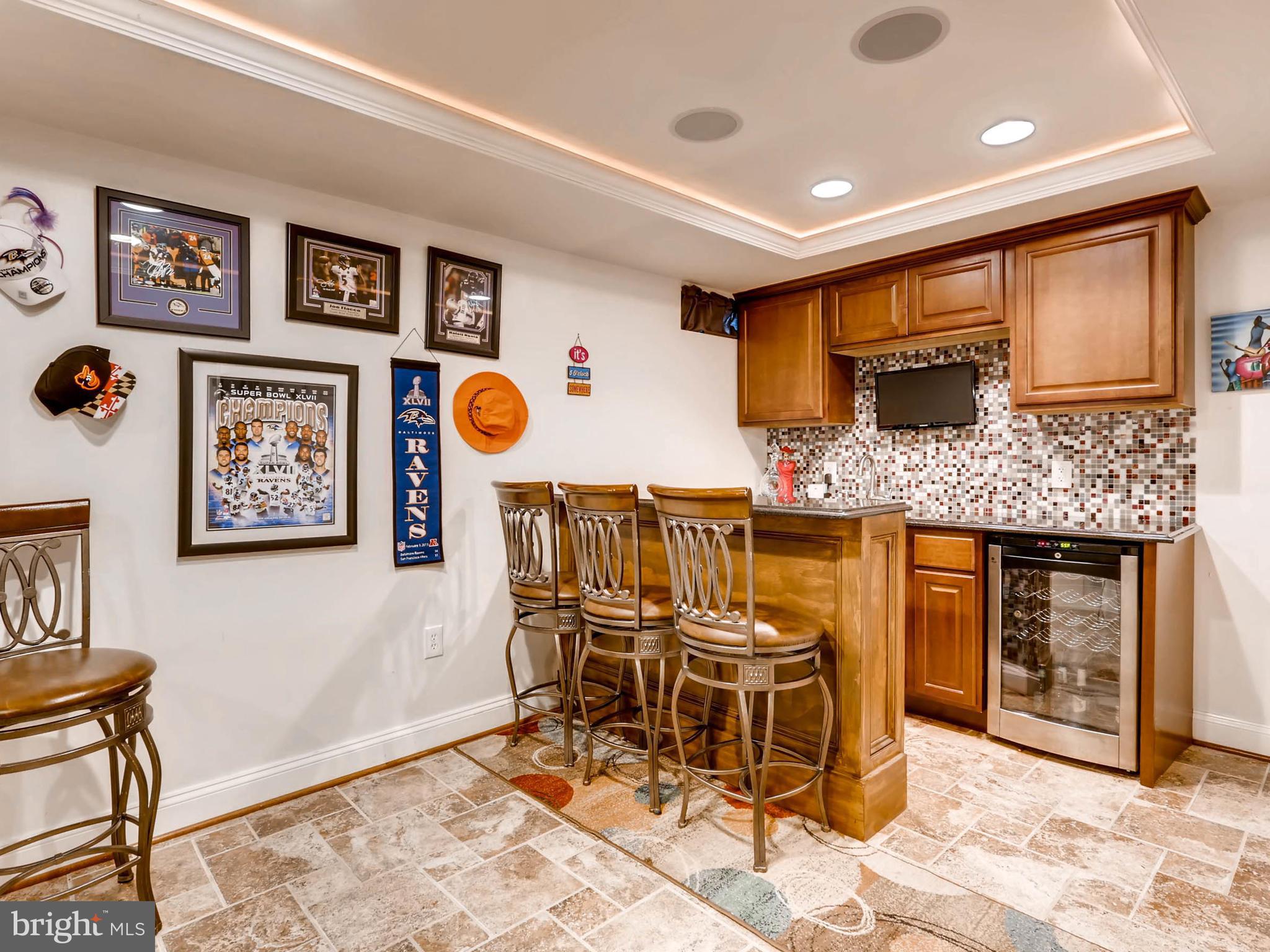 403 North Hammonds Ferry Road Linthicum, MD 21090 - Photo 21 of 30 a kitchen with stainless steel appliances kitchen island granite countertop a refrigerator and chairs