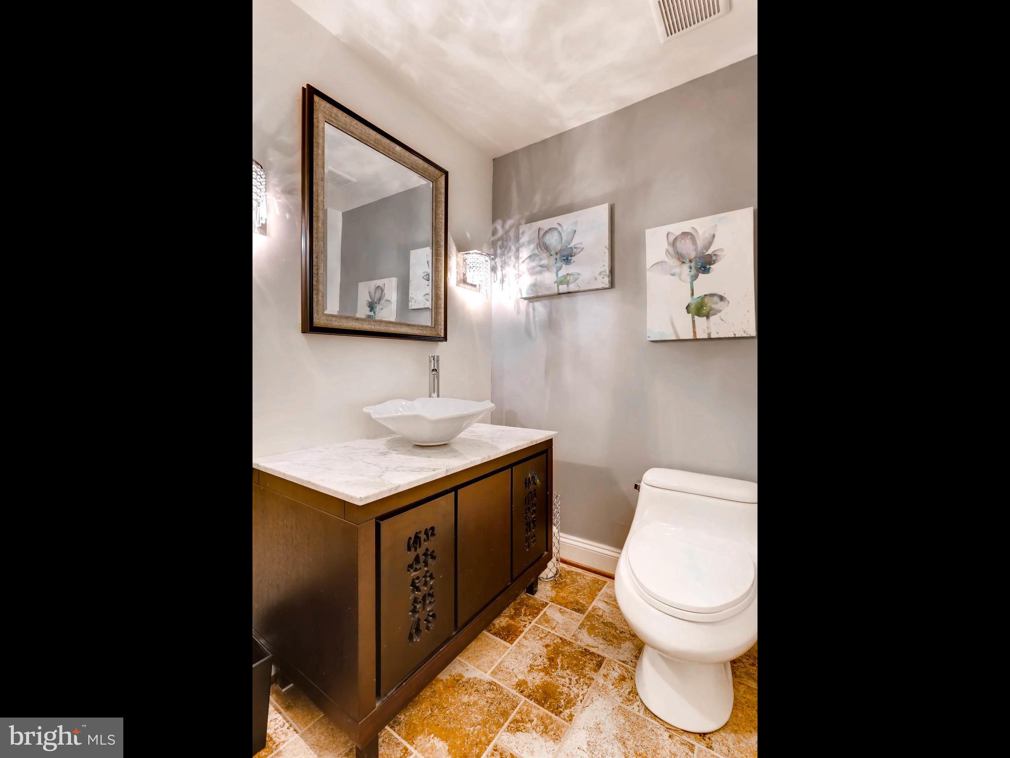 403 North Hammonds Ferry Road Linthicum, MD 21090 - Photo 27 of 30 a bathroom with a toilet a sink and mirror