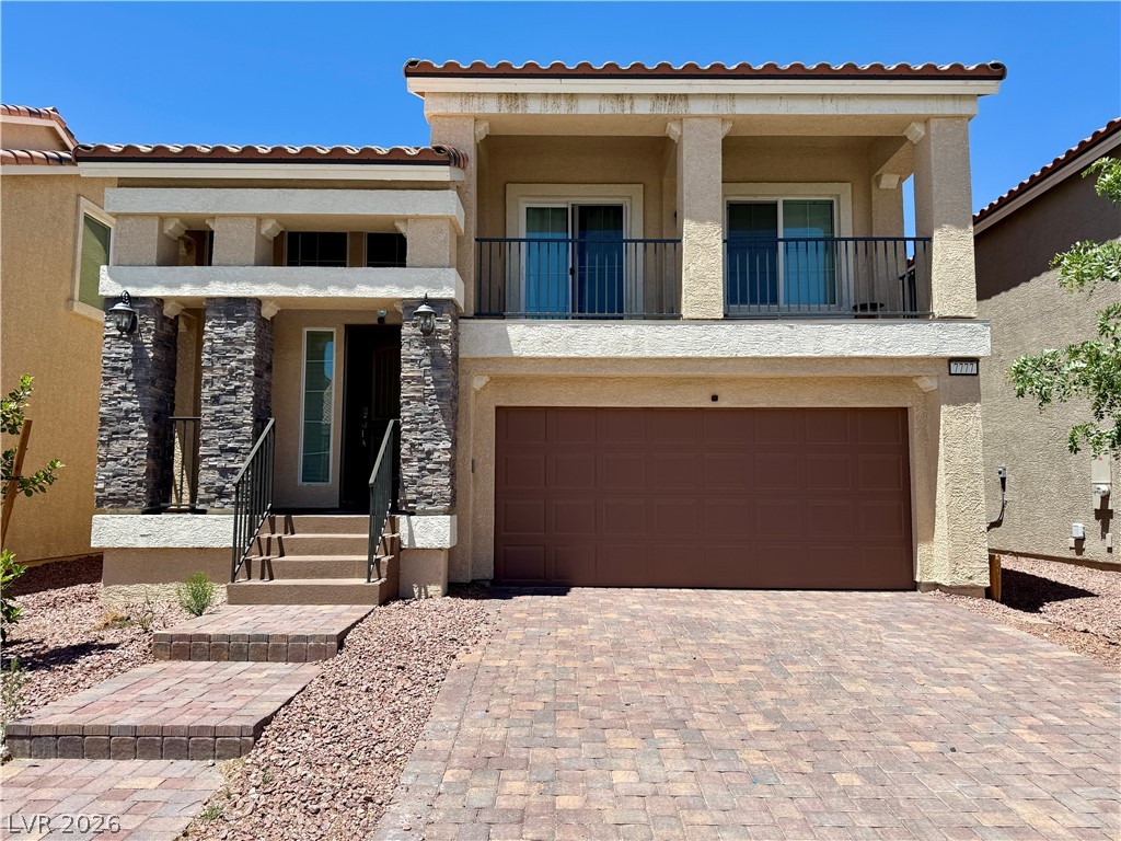 7777 South Westwind Road Las Vegas, NV 89139 - Photo 2 of 46 A classic tiled roofline crowns this residence, featuring a two-car garage and inviting entryway.