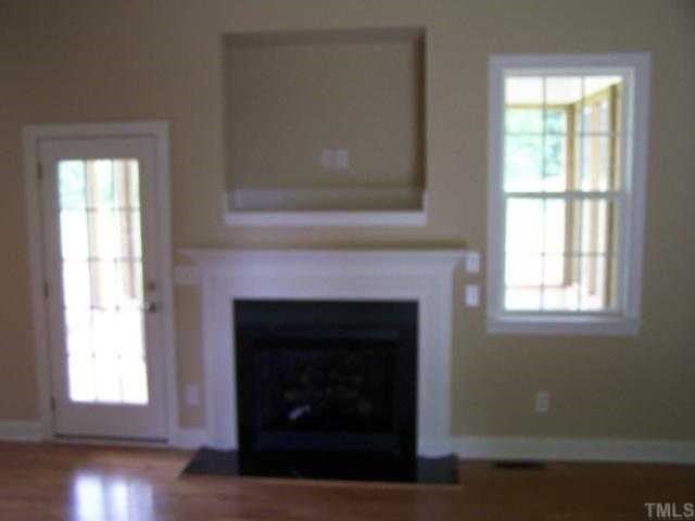 236 West Waycliff Road Henderson, NC 27537 - Photo 3 of 12 The open greatroom with gas log fireplace and entertainment alcove above, hardwood floors and a door to the screen porch