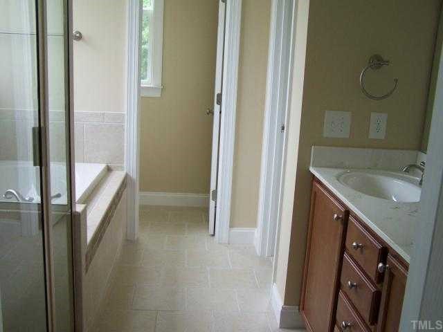 236 West Waycliff Road Henderson, NC 27537 - Photo 5 of 12 The master bedroom suite is on the first floor, the bath had double sink in the vanity, garden tub and separate shower, tile floor