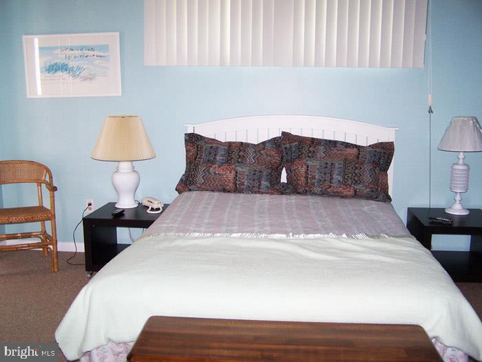 1402 Cedar Street Lewes, DE 19958 - Photo 2 of 6 a bedroom with a bed and a lamp