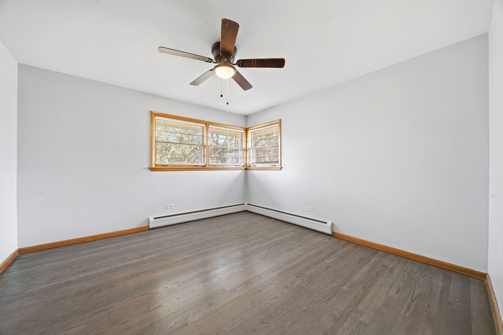 14601 Linder Avenue Midlothian, IL 60445 - Photo 10 of 21 an empty room with wooden floor ceiling fan and windows