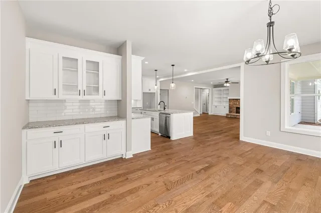 a large kitchen with kitchen island a sink stainless steel appliances and cabinets