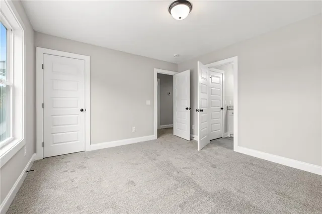 a bathroom with a granite countertop sink a toilet and a mirror
