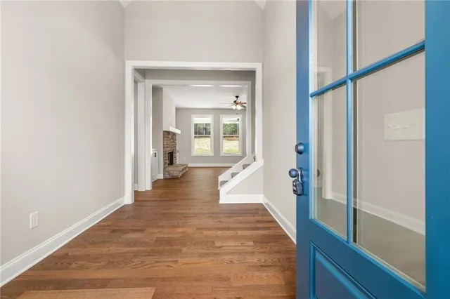 a view of a hallway view with wooden floor and staircase