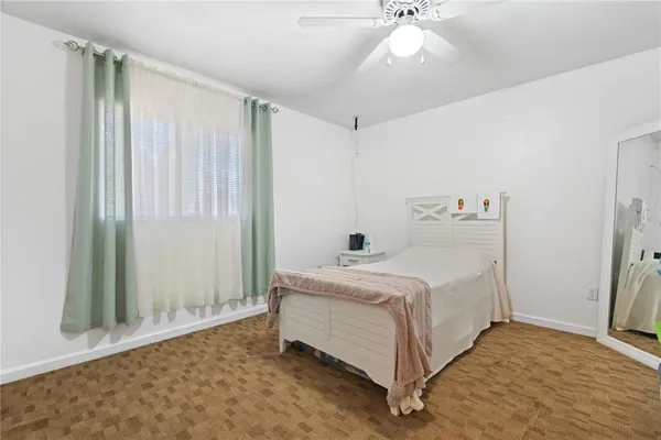 a room with white cabinets and window