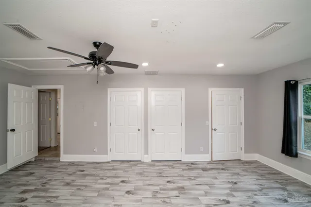 a view of a livingroom with a ceiling fan window and hardwood floor