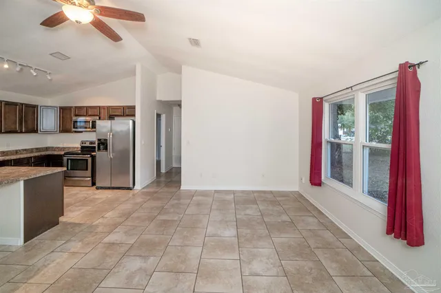 a view of a kitchen with a sink and a refrigerator