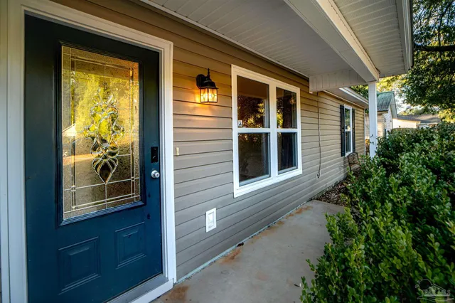 a view of a door of the house and a yard