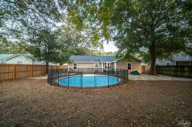 a view of a house with a backyard and a small yard