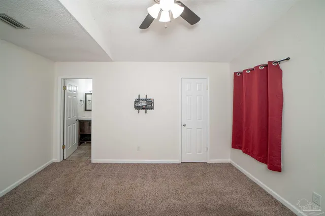 a view of a livingroom with a chandelier fan