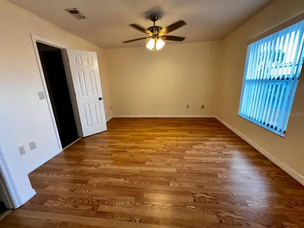 wooden floor in an empty room with a window