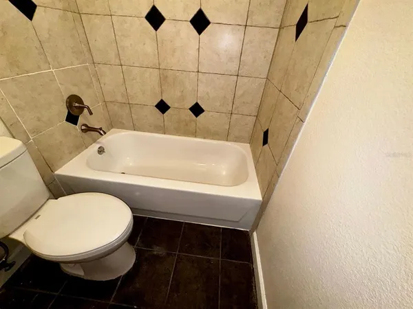 a bathroom with a toilet a sink and bathtub