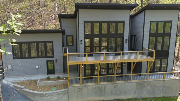 a view of a brick house with a large window and wooden floor