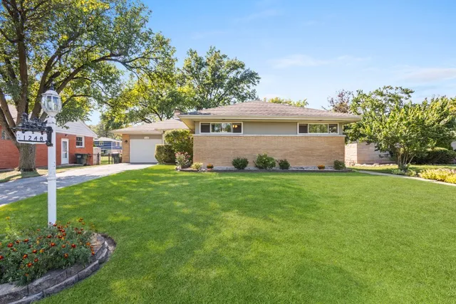 a front view of house with yard and green space