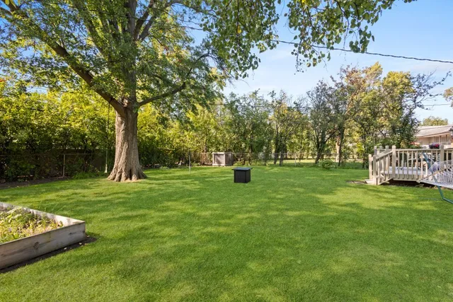 a view of house with a backyard