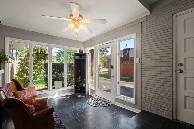 a living room with furniture and large windows