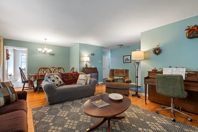 a living room with furniture and a lamp