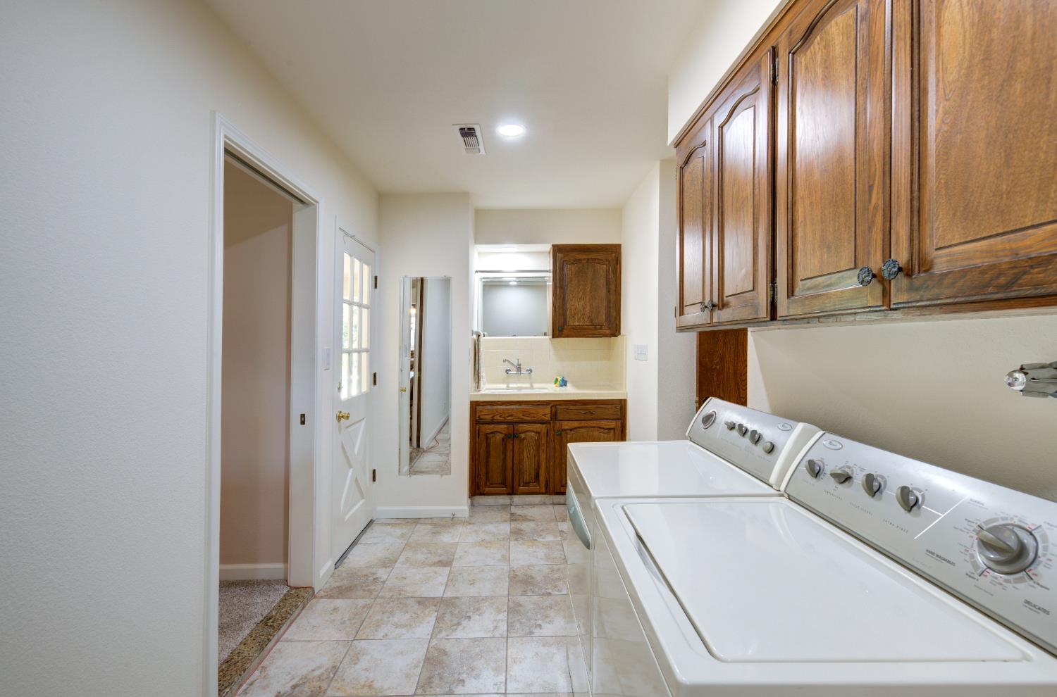 2004 South Renn Avenue Fresno, CA 93727 - Photo 24 of 33 Indoor laundry room with sink area and lots of storage.