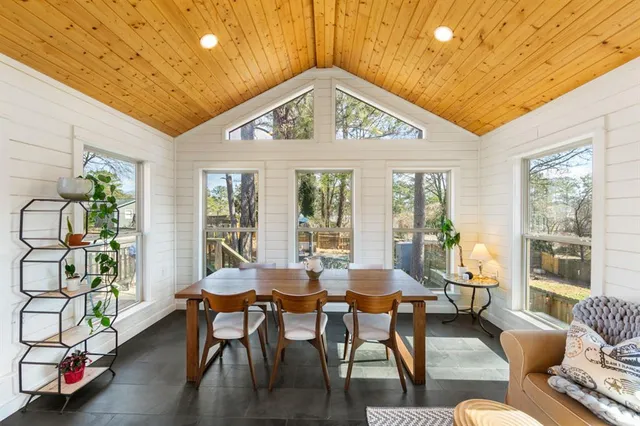 a living room with furniture a window and a table