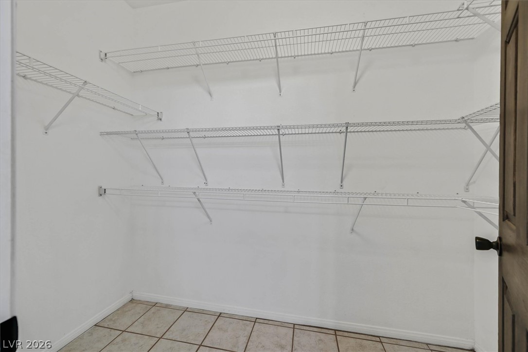 8555 West Russell Road, Unit 2069 Las Vegas, NV 89113 - Photo 21 of 27 Ample storage solutions await in this naturally illuminated walk-in closet with durable tile flooring.