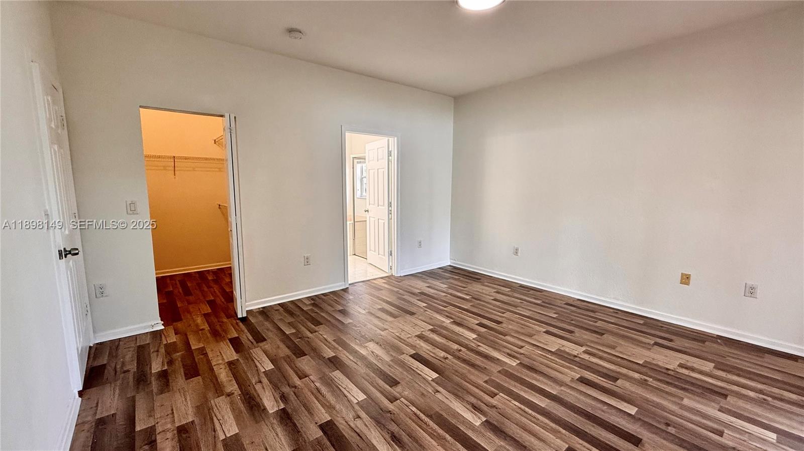 13843 Southwest 31st Street Miramar, FL 33027 - Photo 21 of 58 a view of a room with wooden floor and wall painting