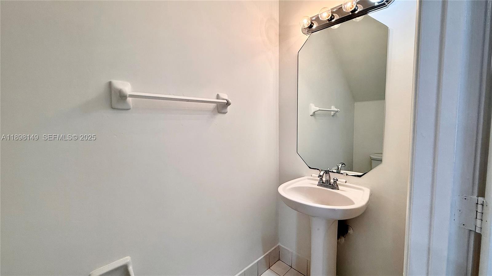 13843 Southwest 31st Street Miramar, FL 33027 - Photo 26 of 58 a bathroom with a sink and mirror