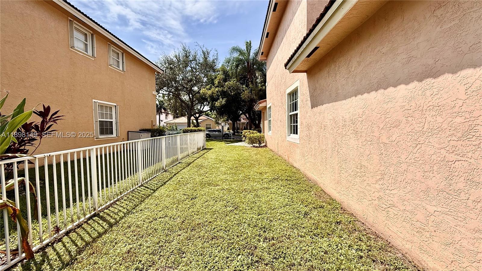 13843 Southwest 31st Street Miramar, FL 33027 - Photo 49 of 58 a view of a backyard with wooden fence