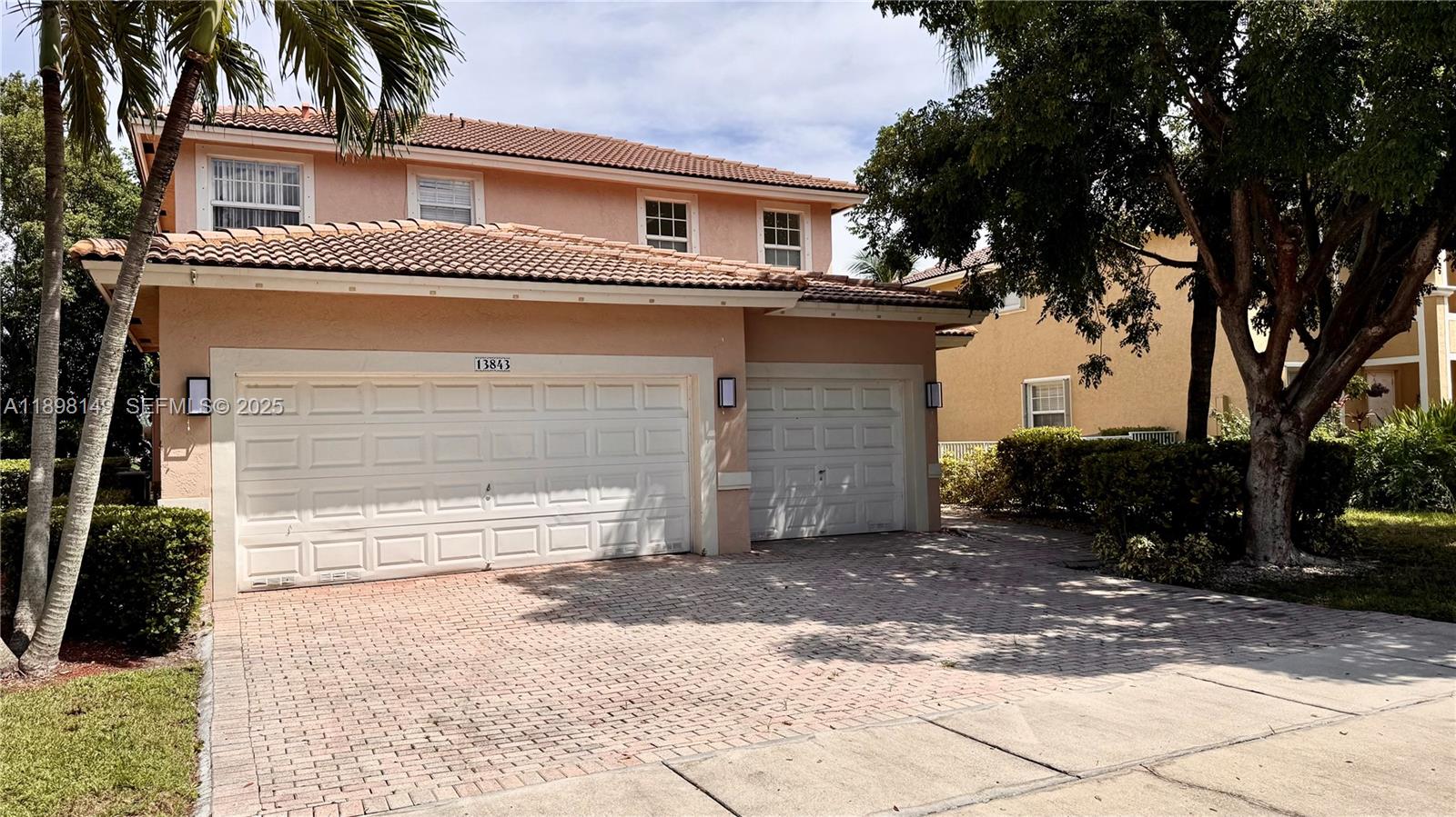 13843 Southwest 31st Street Miramar, FL 33027 - Photo 58 of 58 a front view of a house with a yard and garage
