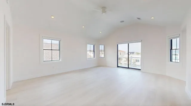 an empty room with windows and closet