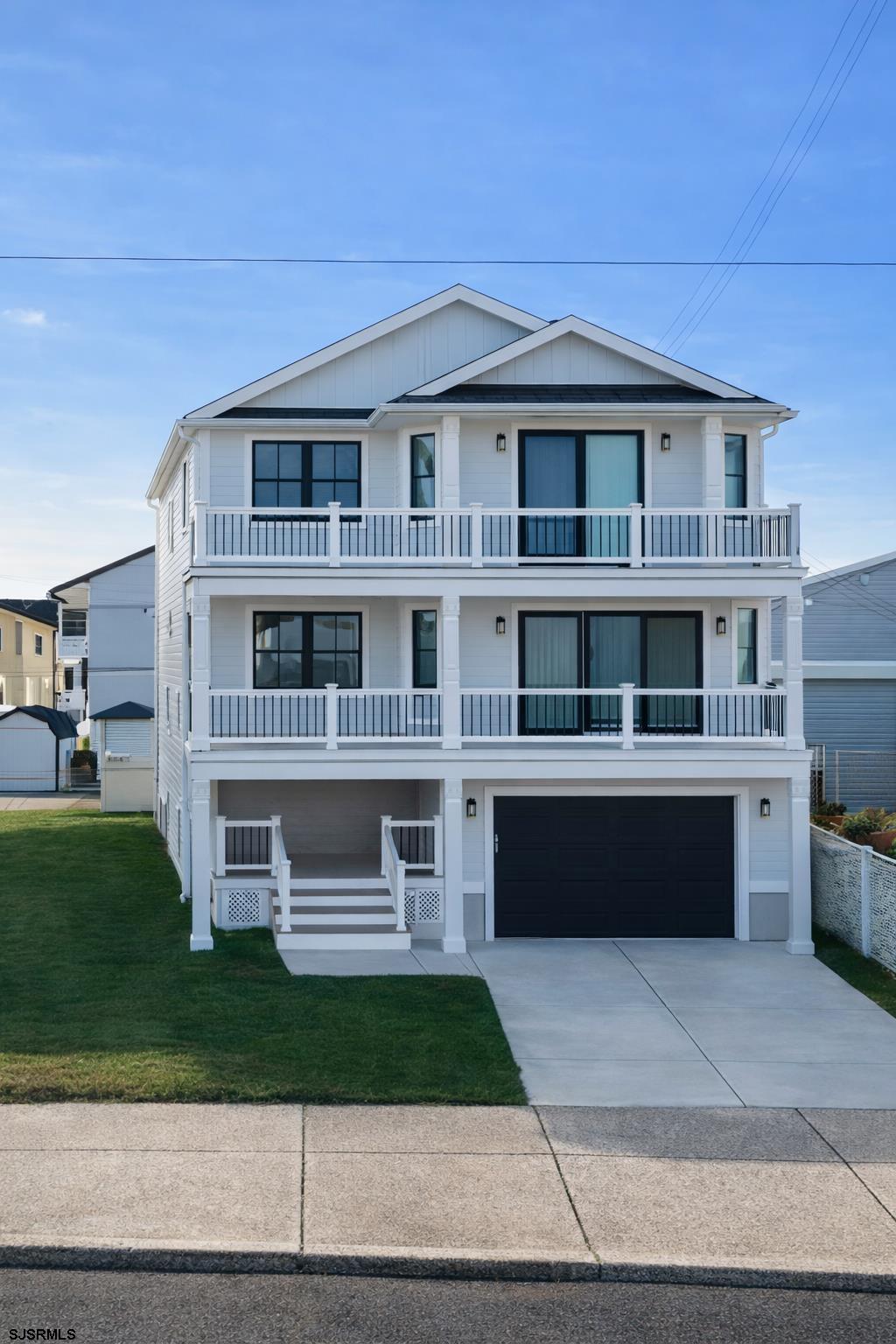 250 8th Street South Brigantine, NJ 08203 - Photo 2 of 33 a front view of a house with a yard