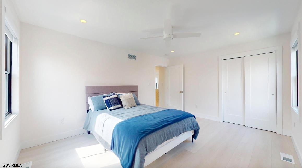 250 8th Street South Brigantine, NJ 08203 - Photo 22 of 34 a bedroom with a bed and a night stand