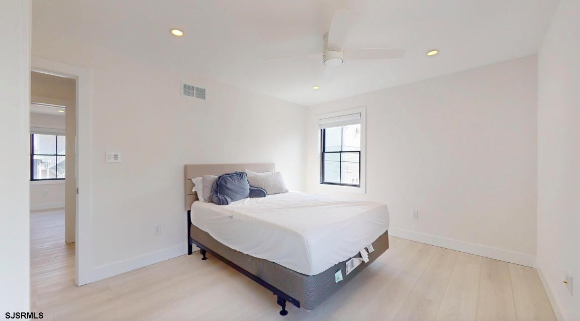 250 8th Street South Brigantine, NJ 08203 - Photo 23 of 33 a bedroom with a bed and window