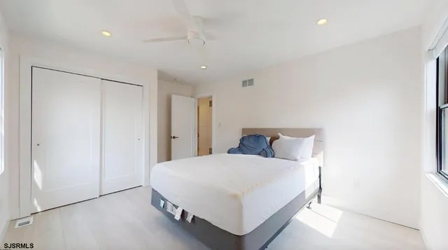 a large bedroom with a bed and a closet