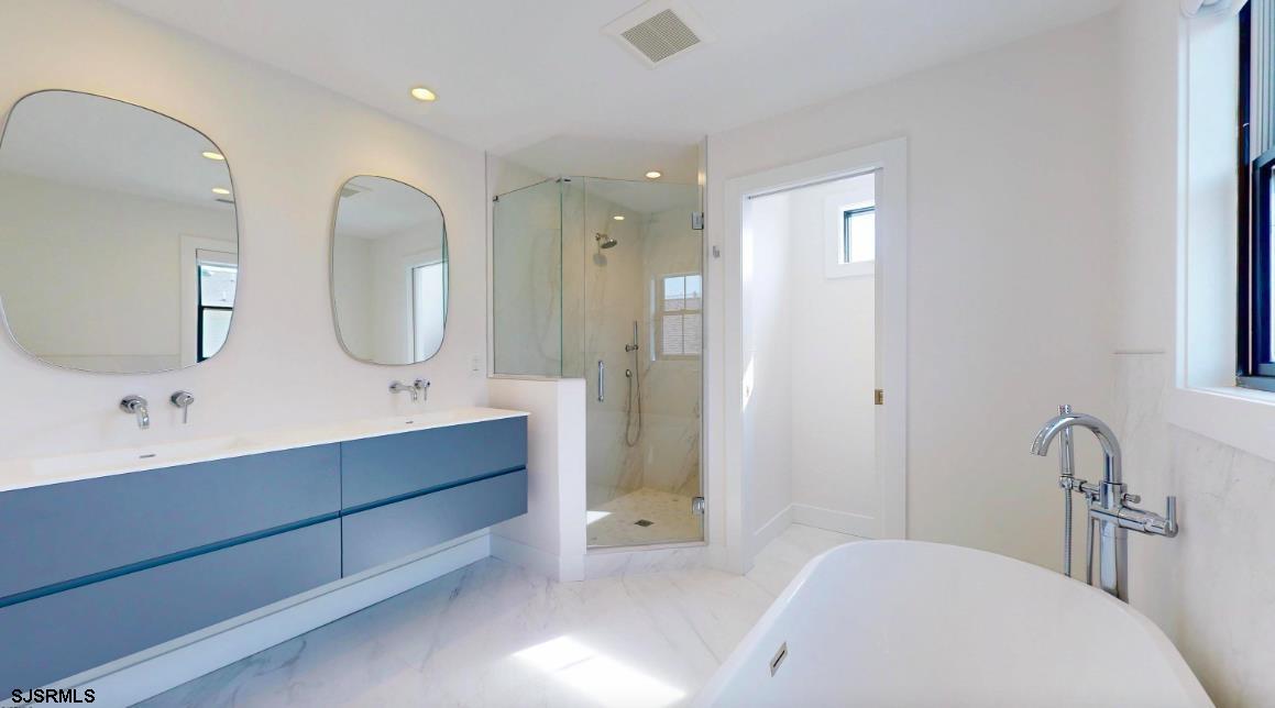 250 8th Street South Brigantine, NJ 08203 - Photo 29 of 34 a spacious bathroom with a double vanity sink and a mirror