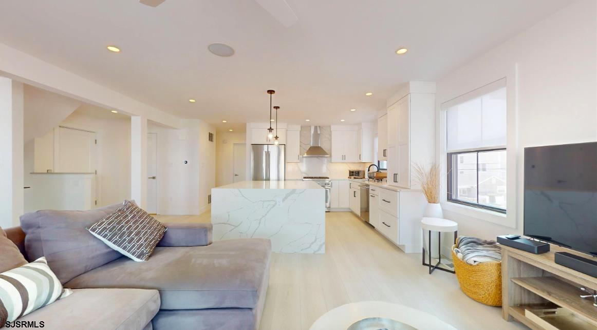 250 8th Street South Brigantine, NJ 08203 - Photo 10 of 33 a living room with furniture and a flat screen tv