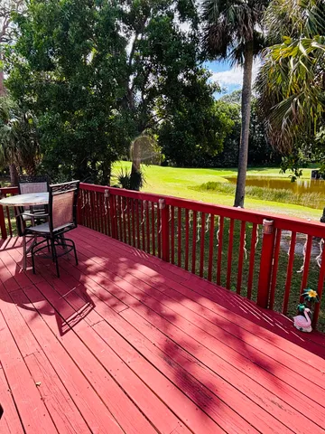 a view of a house with a big yard and large trees