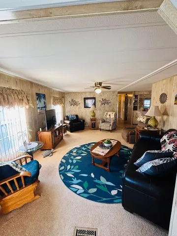 a living room with furniture and a gym window