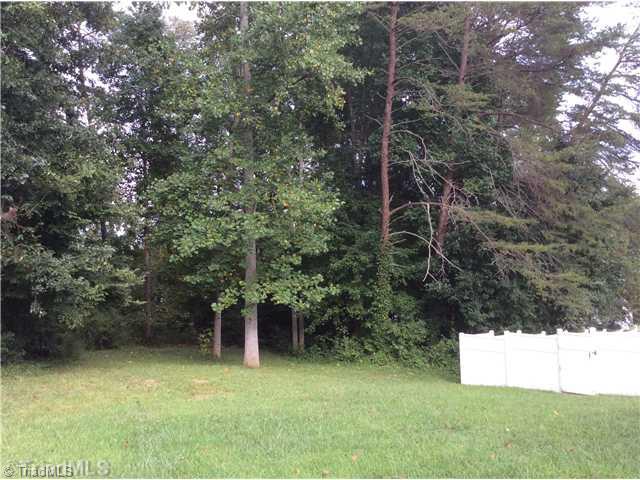 7502 Keating Drive Oak Ridge, NC 27310 - Photo 14 of 16 Yard/Garden. The peaceful backyard goes beyond the woods with a nice sitting area under the trees.