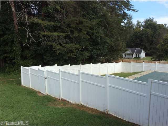 7502 Keating Drive Oak Ridge, NC 27310 - Photo 15 of 16 Yard/Garden. The in ground pool is nicely fenced in.