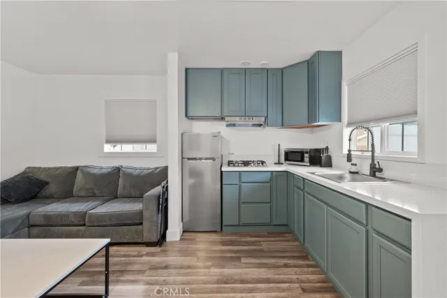 a kitchen with a sink cabinets and stainless steel appliances