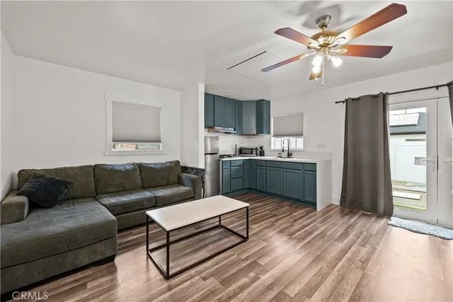 a living room with kitchen island furniture and a wooden floor