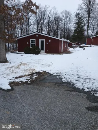 a view of large house with a yard covered in snow