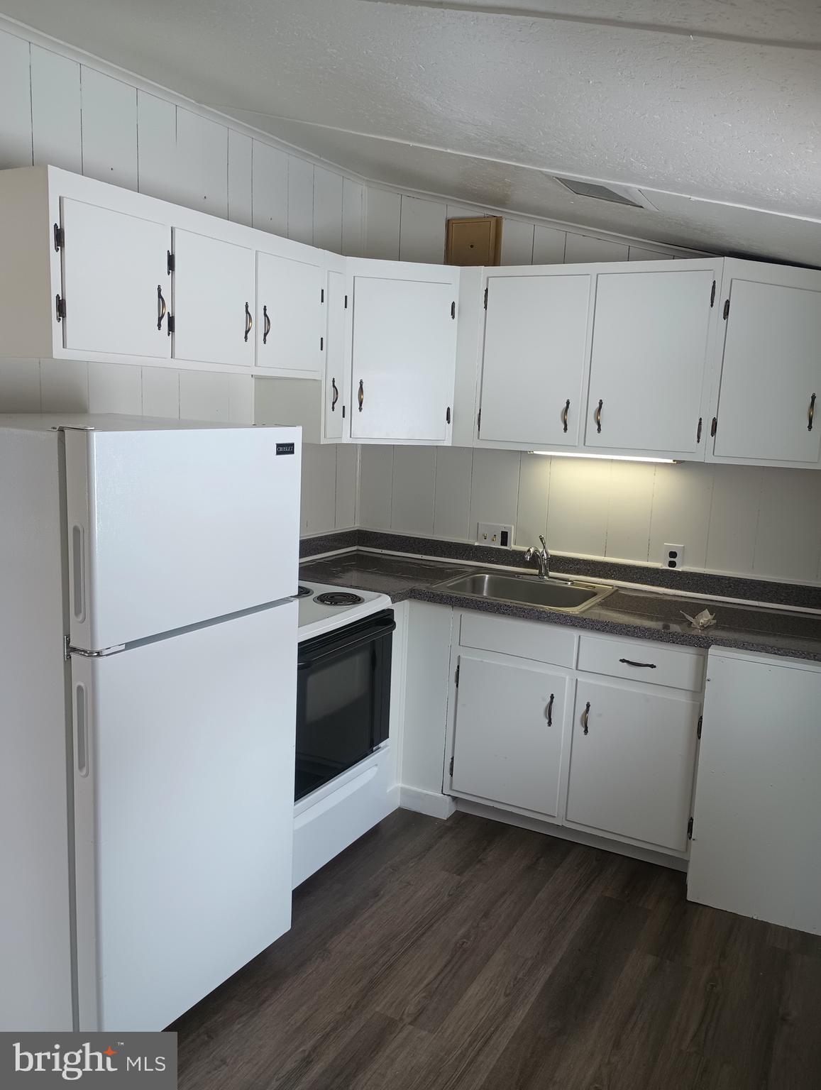356 Keneagy Hill Road, Unit 27 Ronks, PA 17572 - Photo 2 of 10 a kitchen with granite countertop white cabinets and white appliances