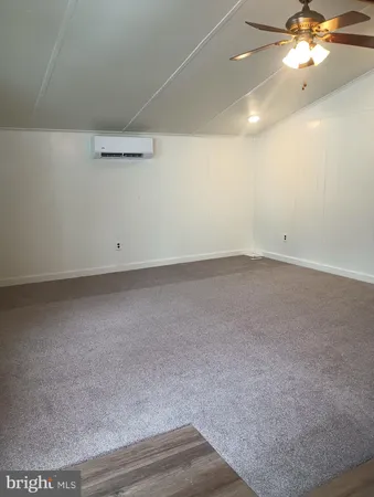 an empty room with a chandelier fan