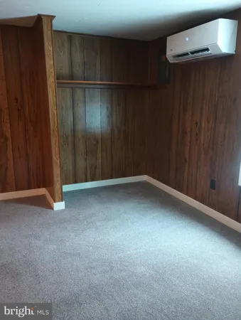 a view of empty room with wooden walls