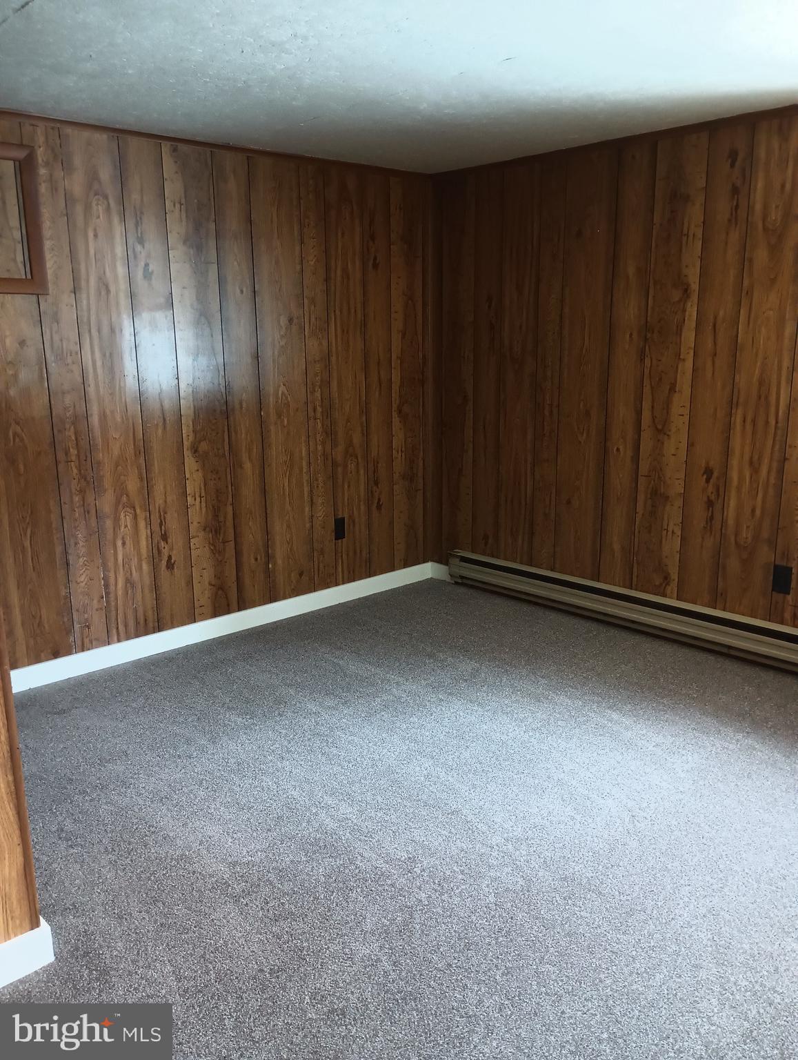 356 Keneagy Hill Road, Unit 27 Ronks, PA 17572 - Photo 7 of 10 a view of an empty room with wooden walls